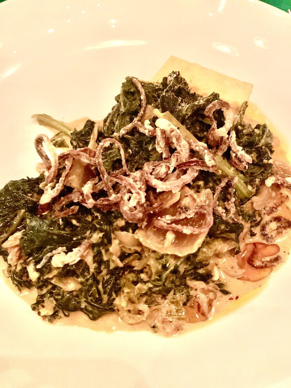 Creamed Kale with fried shallots on a polenta cake is rich and delicious, share with your table mates